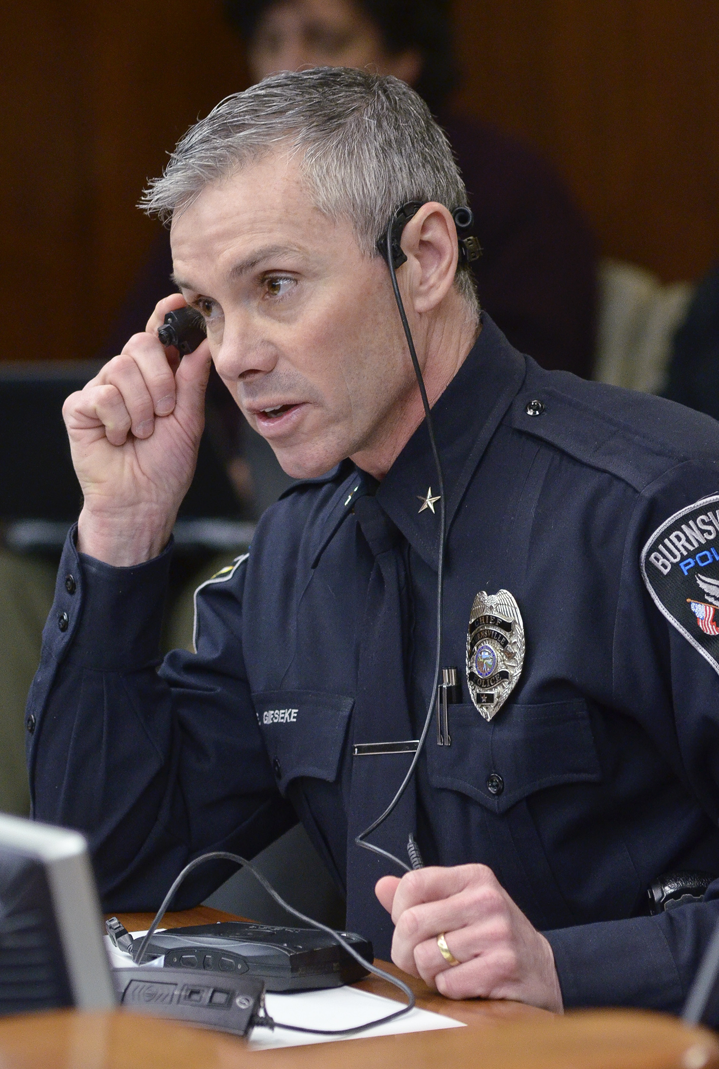 Burnsville Police Chief Eric Gieseke shows members of the House Civil Law and Data Practices Committee several types of police body-mounted cameras during a Feb. 10 overview of body camera technology. Photo by Andrew VonBank